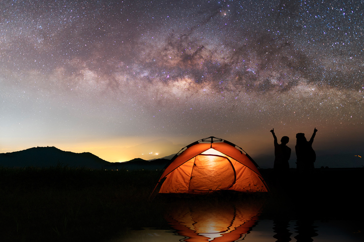 Two girls outdoor camping outdoor on Holiday majestic milky way .